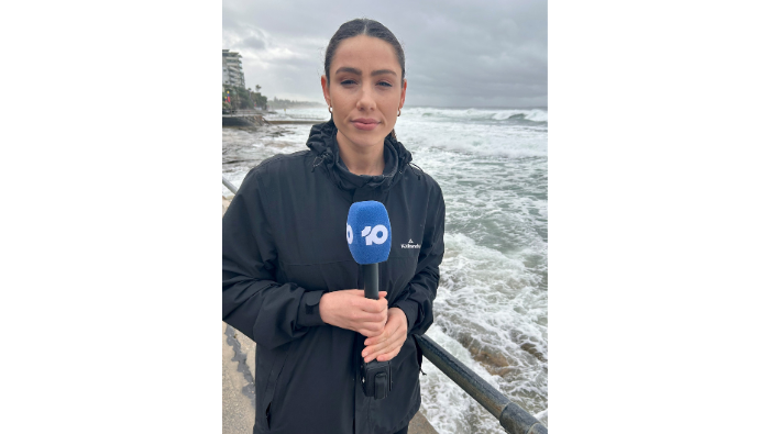 Branded microphone windshield reporting on the wild NSW weather